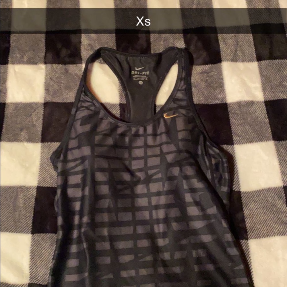 Black nike tank top with gold symbol and built in sports bra